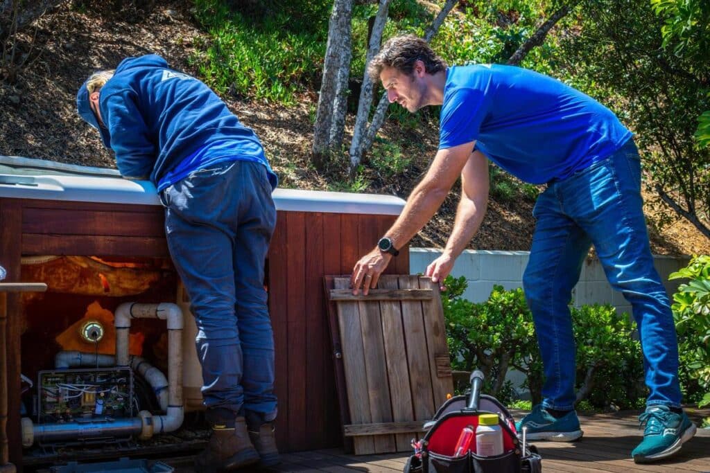 two men working on spa