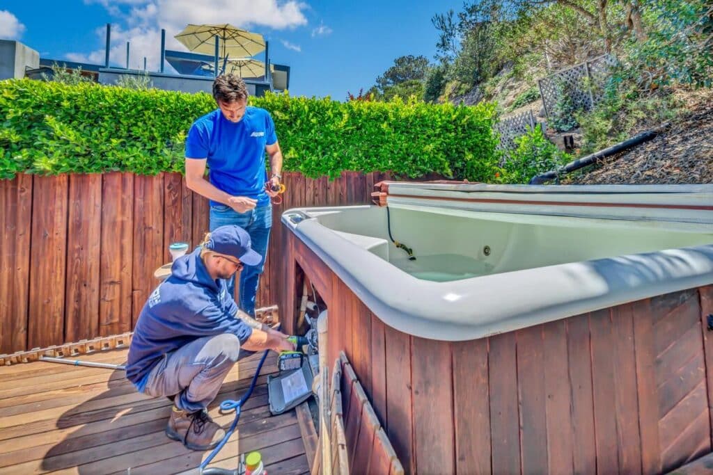 Two men working on hot tub