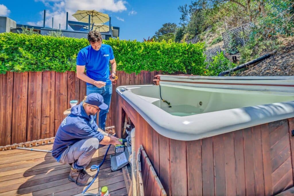 Two men working on hot tub